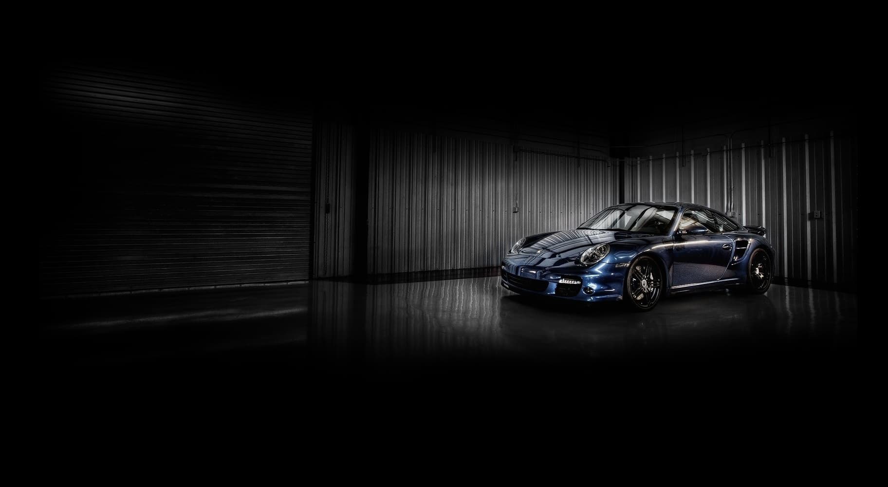 Porsche 911 in dramatic lighting at The Asylum storage facility